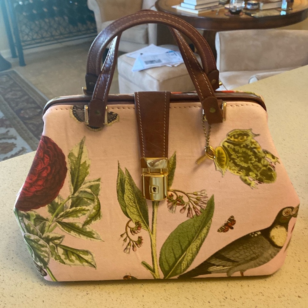 Colorful cloth bag with leather base and handle. Gold trim.